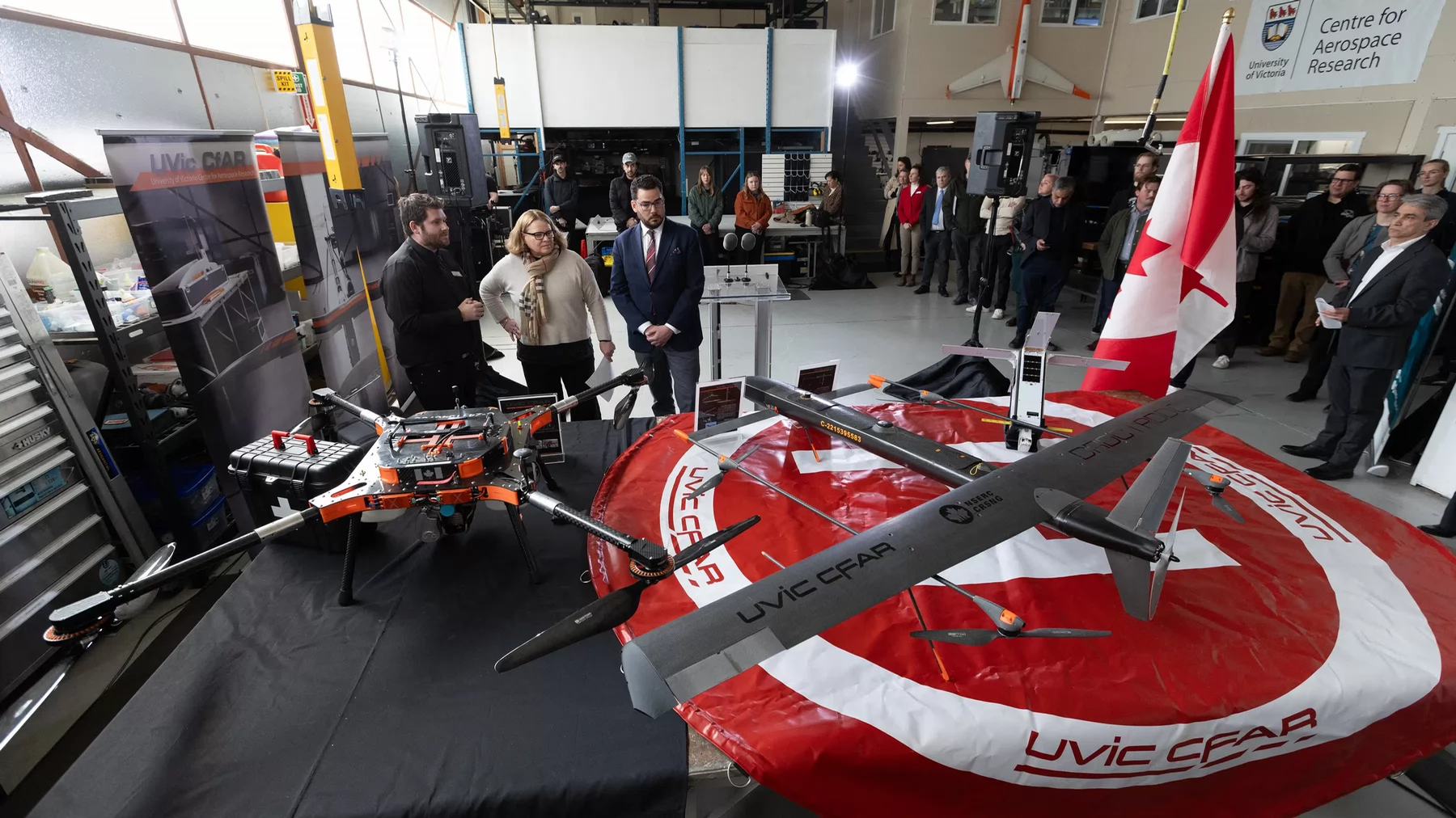 A group of people gather to look at equipment for the Centre for Aerospace Research. 