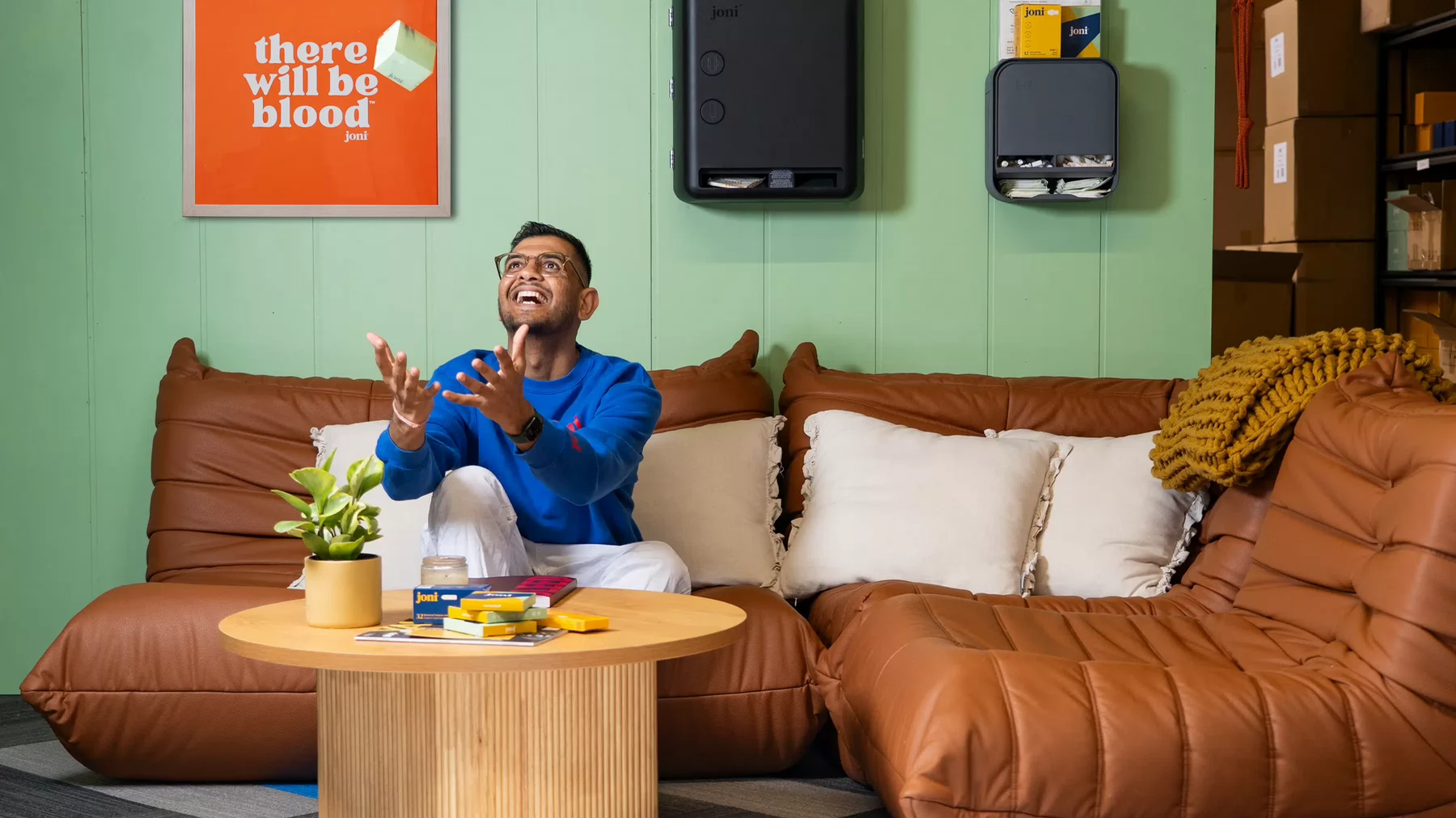 Jayesh Vekariya throws a box of joni products into the air.