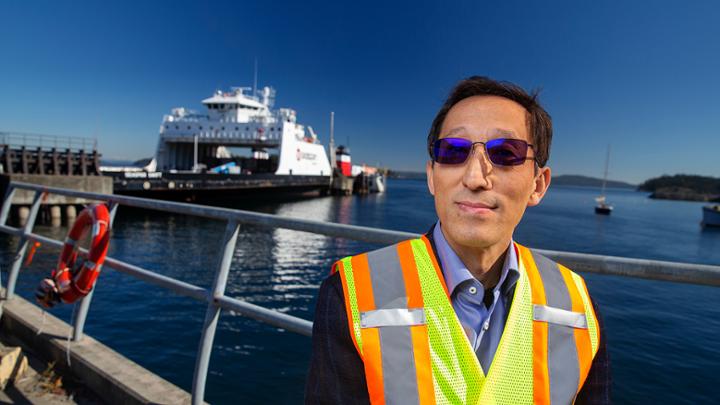 Dr. Zuomin Dong in front of a ferry