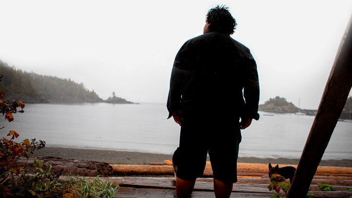Darrell WIlliams Jr. stands in the area pictured in the article's first image, with his back to the camera facing the Yuquot inlet