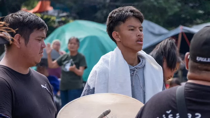 Stirring songs carry across generations in celebration of the community’s recent achievements.