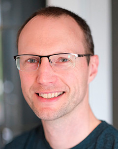 A close-up portrait of ACET Executive Director Curran Crawford