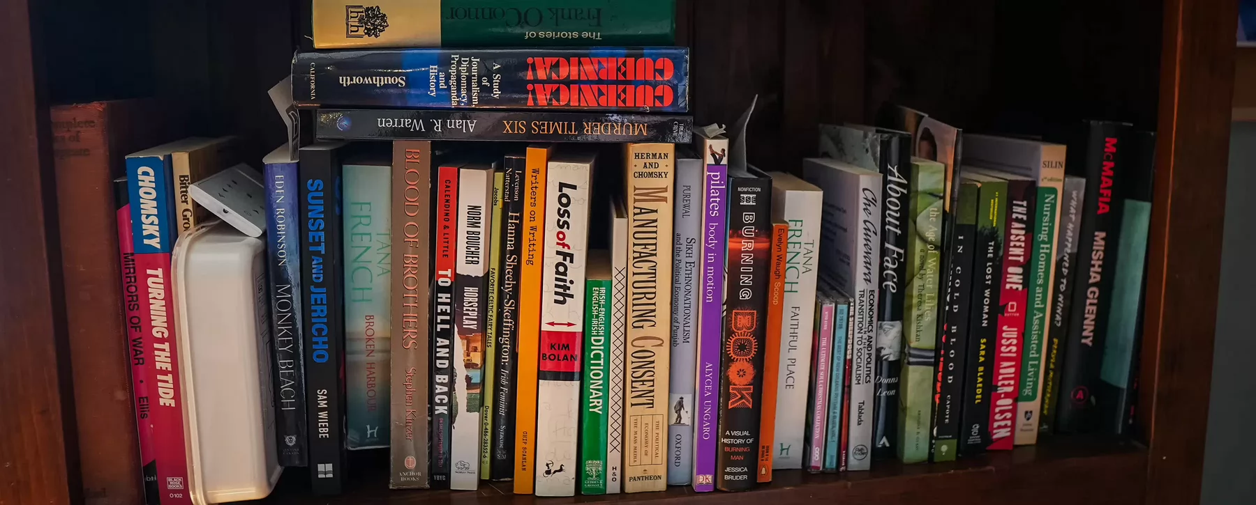 A cluttered bookshelf. 