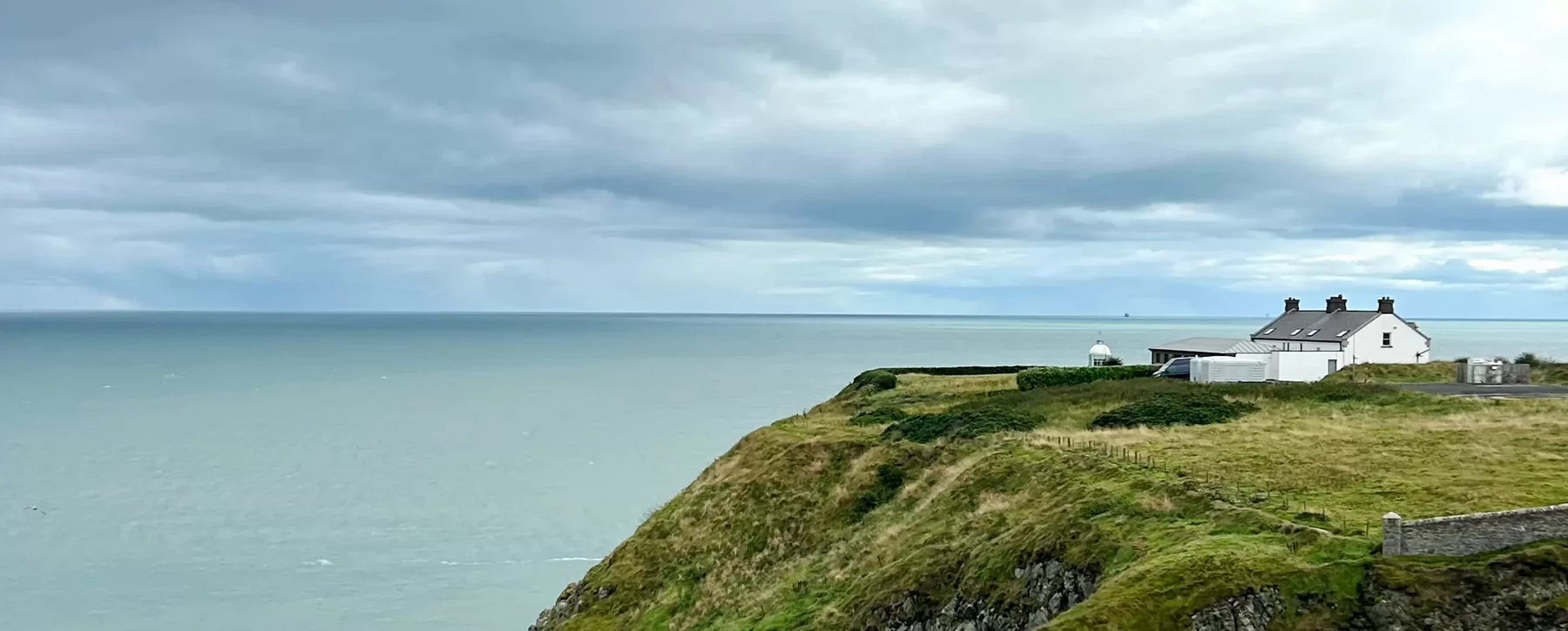 A house sitting atop a bluff as part of the Howth Coastal Walk.