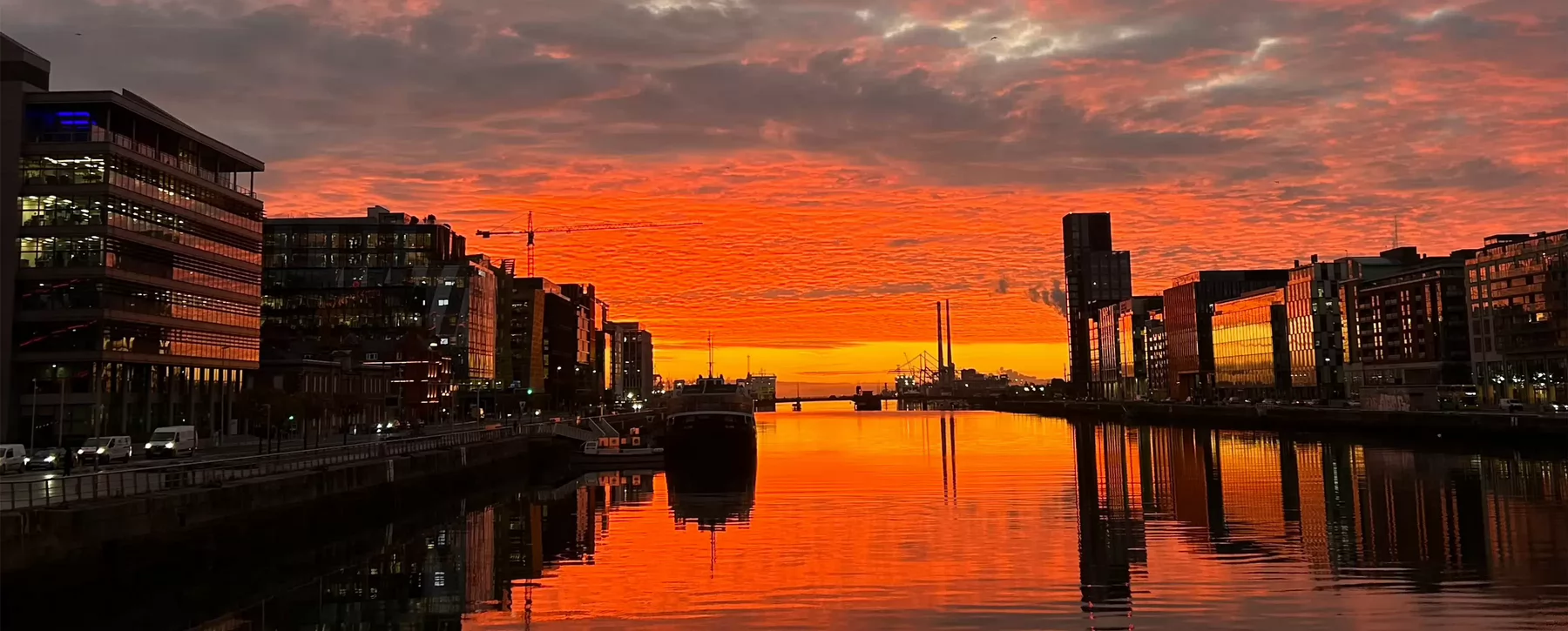 Orange skies over the River Liffey at sunrise.