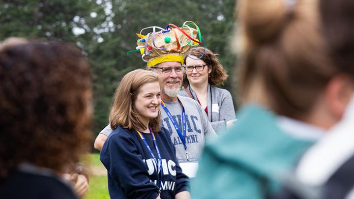 People wearing UVic alumni shirts at outdoor gathering