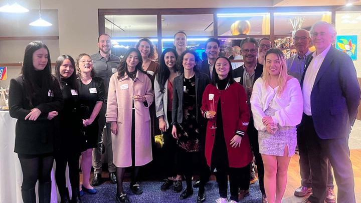 Group of people indoors smiling at camera