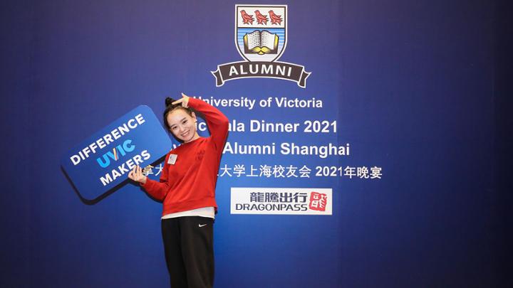 Woman holding a sign that reads UVic difference makers