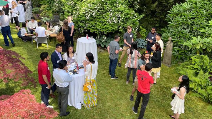 People gathered talking in a garden