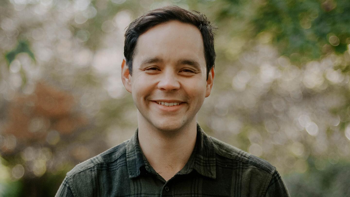 Man in plaid shirt smiling
