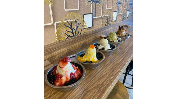 Five dishes of shaved ice cream desserts.