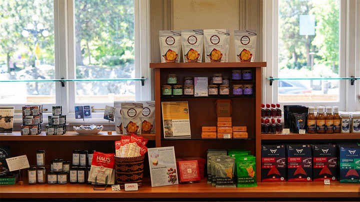 A shop display of various jars, bags and packages of food.