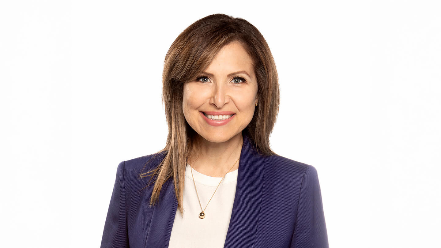 Woman with shoulder length hair smiling. 
