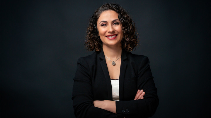 Woman smiling with her arms crossed.