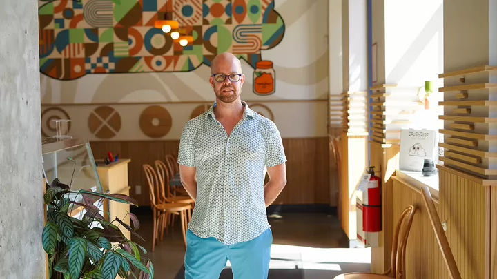 Vincent Vanderheide standing in the pizza restaurant he co-owns called Dough Eyes.