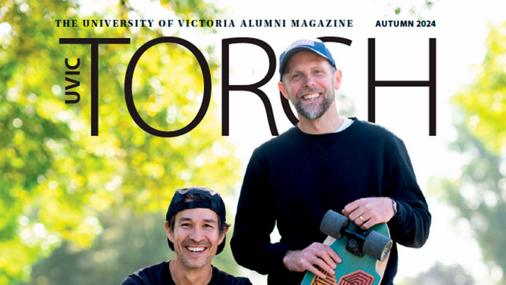 Two people holding skateboards with the words "The University of Victoria Alumni Magazine Torch" above their heads
