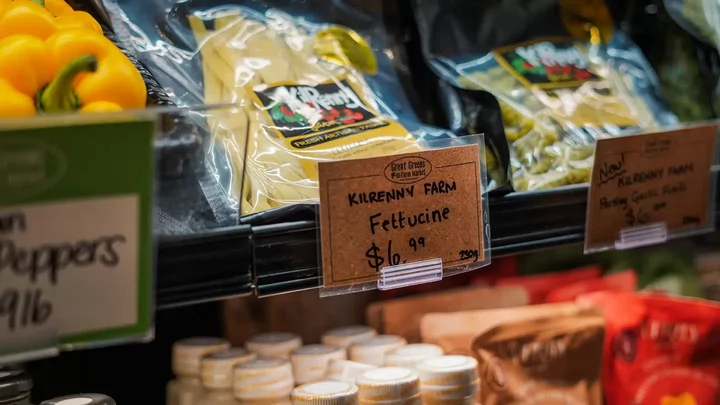 Packages of fettuccine noodles on a grocery store shelf. 