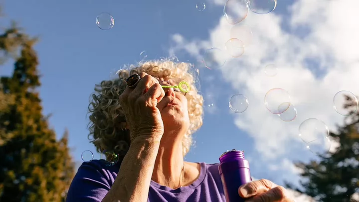 A woman blowing bubbles.