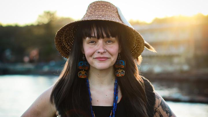 Person wearing woven hat outside.
