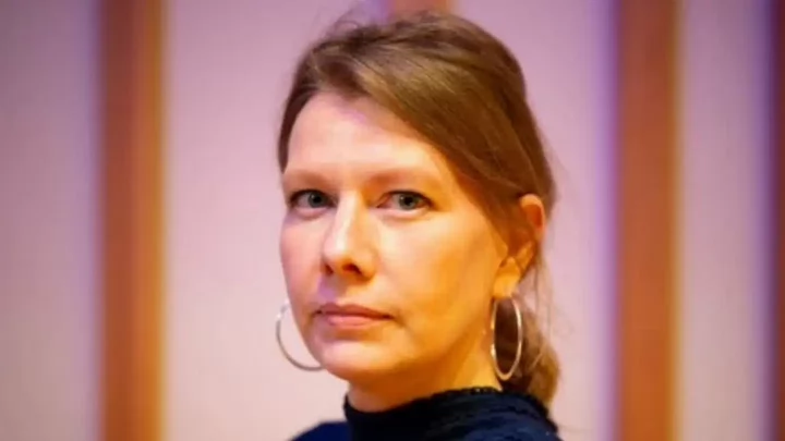 A woman with hoop earrings. 