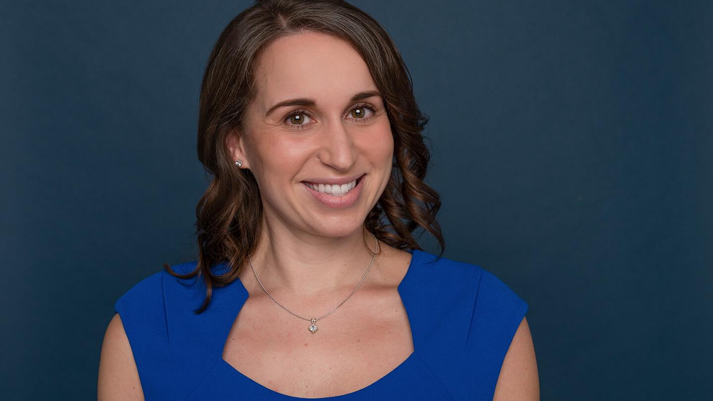 Woman in blue outfit smiling