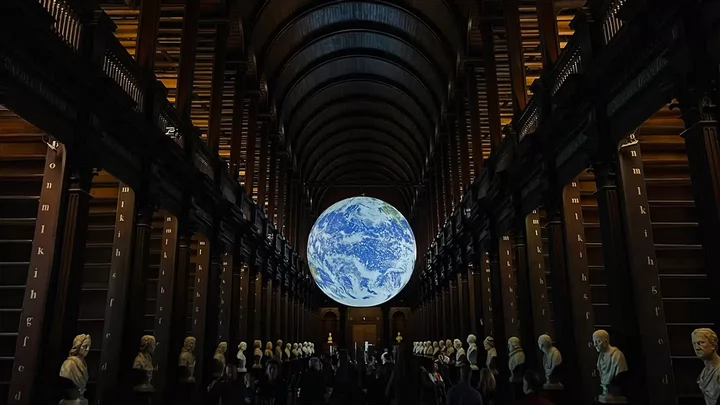 An illuminated globe hanging from the ceiling of the Long Room library at Trinity College in Dublin, Ireland. 