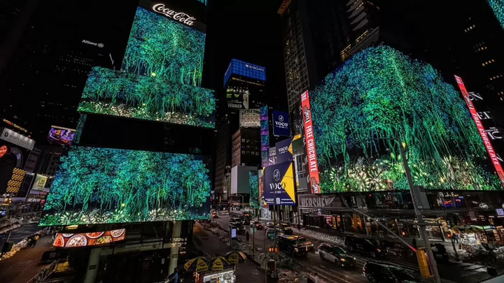 A digital image of a tree on a digital billboard in New York City's Times Square.