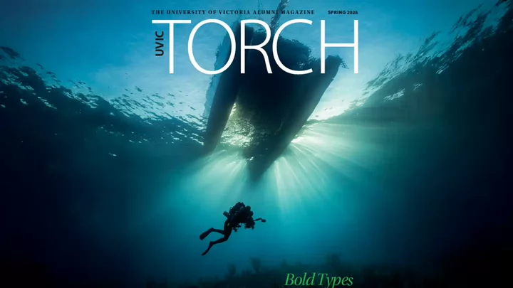 Magazine cover of Torch Alumni Magazine featuring a photo of a scuba diver swimming underwater with a boat floating on the surface and the headline Bold Types.