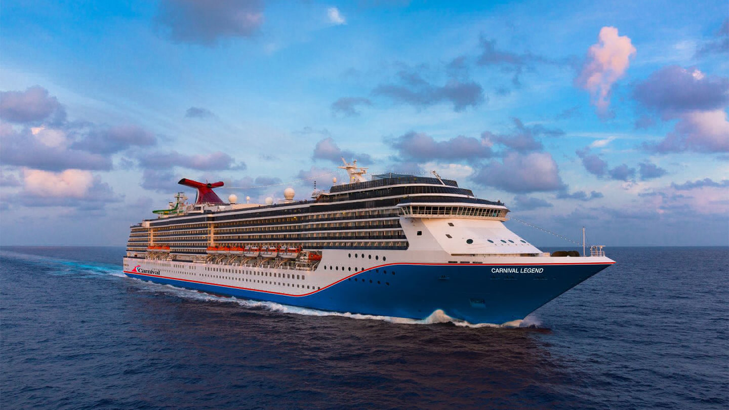 Cruise ship called Carnival Legend sailing on a the ocean.