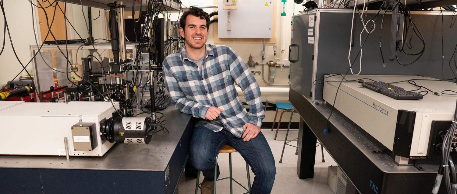 Rory Hills leans on scientific equipment