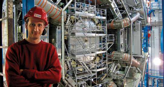Michel Lefebvre standing in front of the Hadron Collider