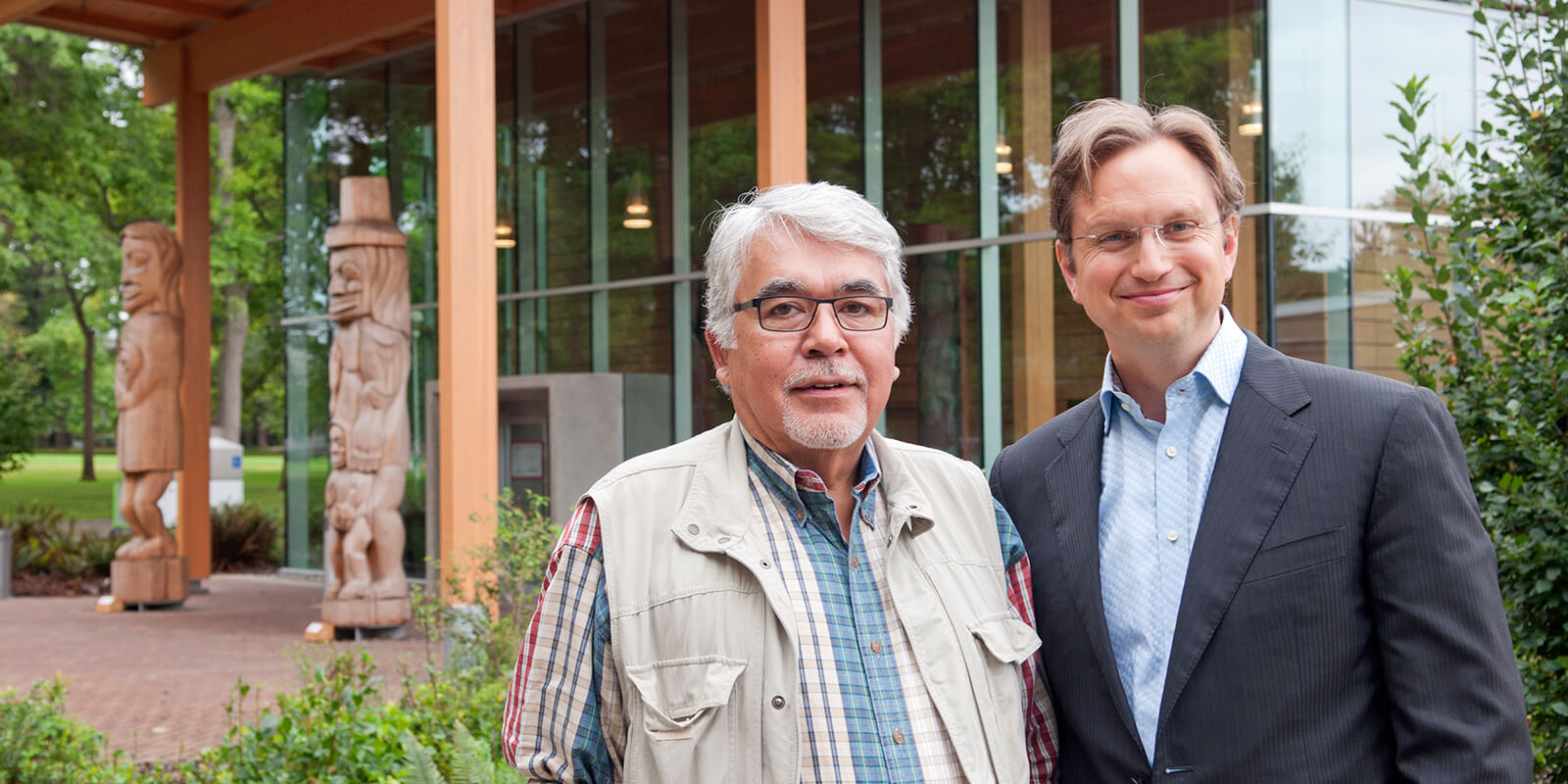 Frank Parnell of the Tribal Resources Investment Corporation and Brent Mainprize of Gustavson in front of First Peoples House at UVic