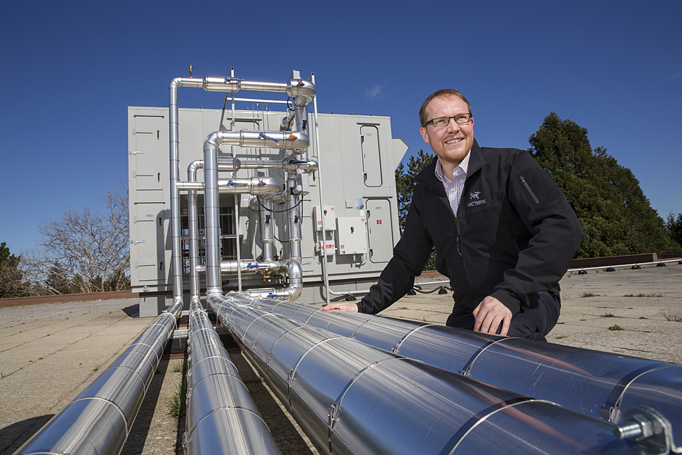 David Adams, Uvic's Energy Mananger, with the heat recovery air handling unit on the roof of the McKinnon Building