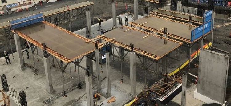 Construction site depicting vertical structures supporting falsework.