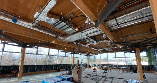 Construction site depicting the mass timber in the new dining hall in Building 1