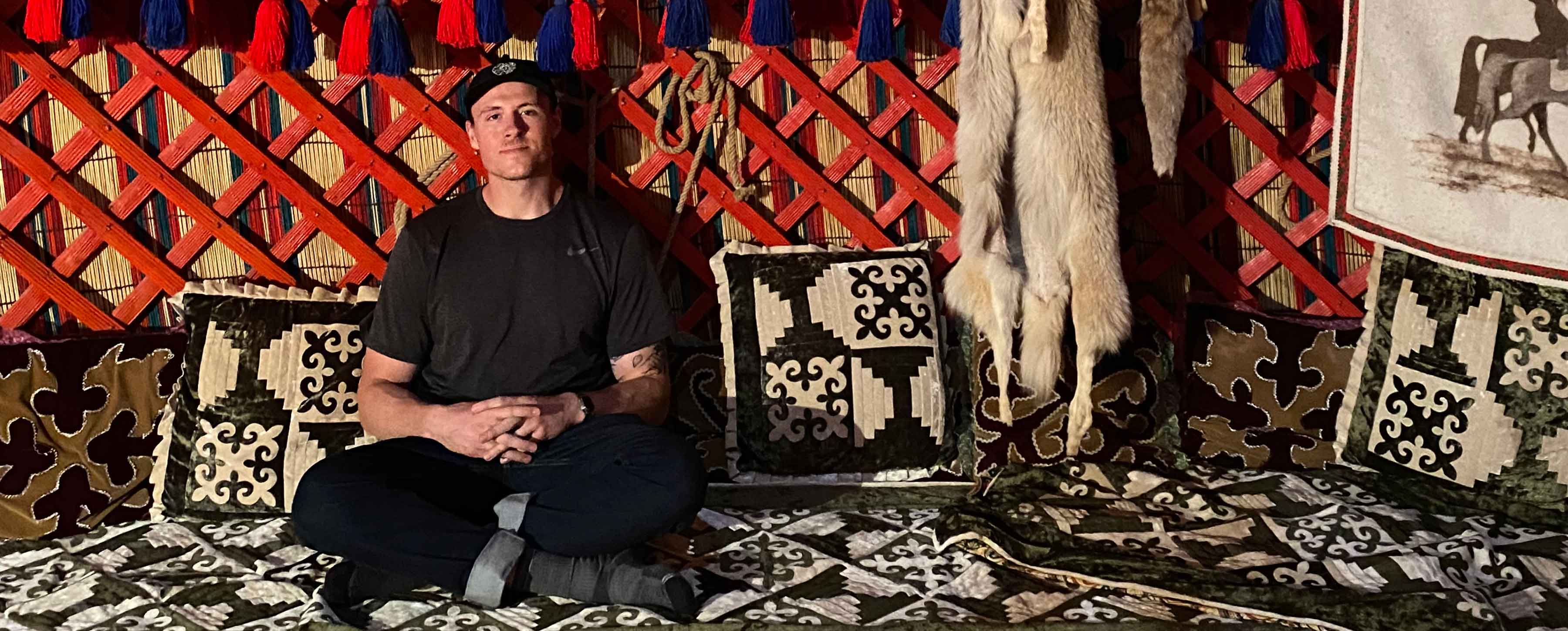 A student sitting in a hut in Mongolia.