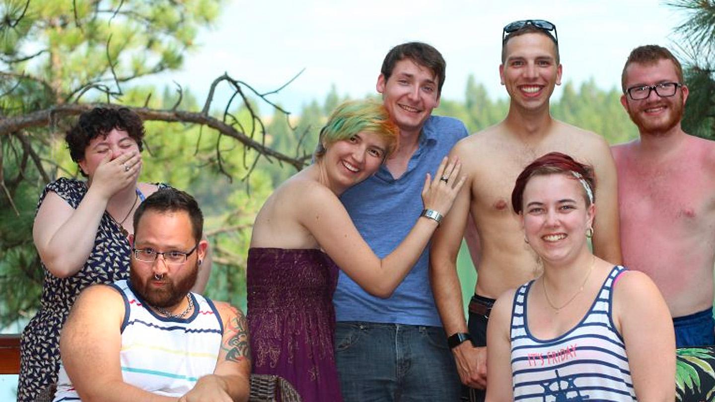 Seven students lined up smiling and laughing
