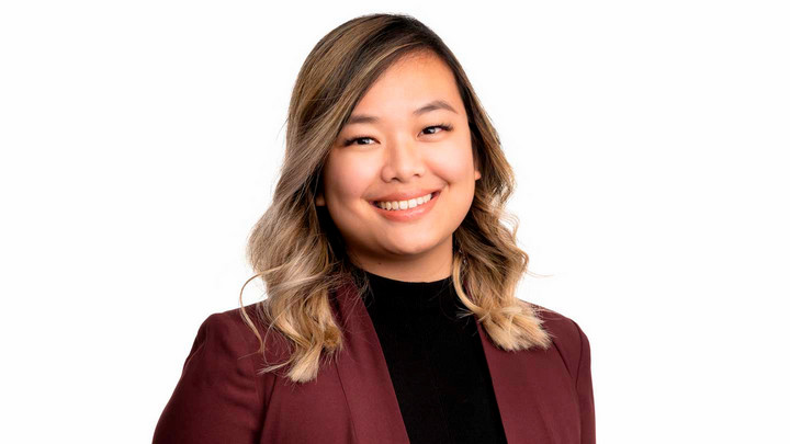 A photo of a woman of Asian heritage smiling at the camera.