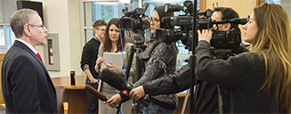 Faculty member being interviewed by media