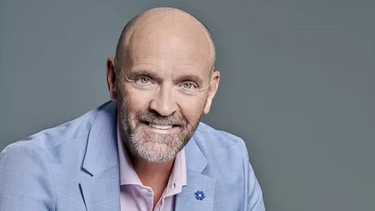 Photo of smiling older man with trimmed grey beard