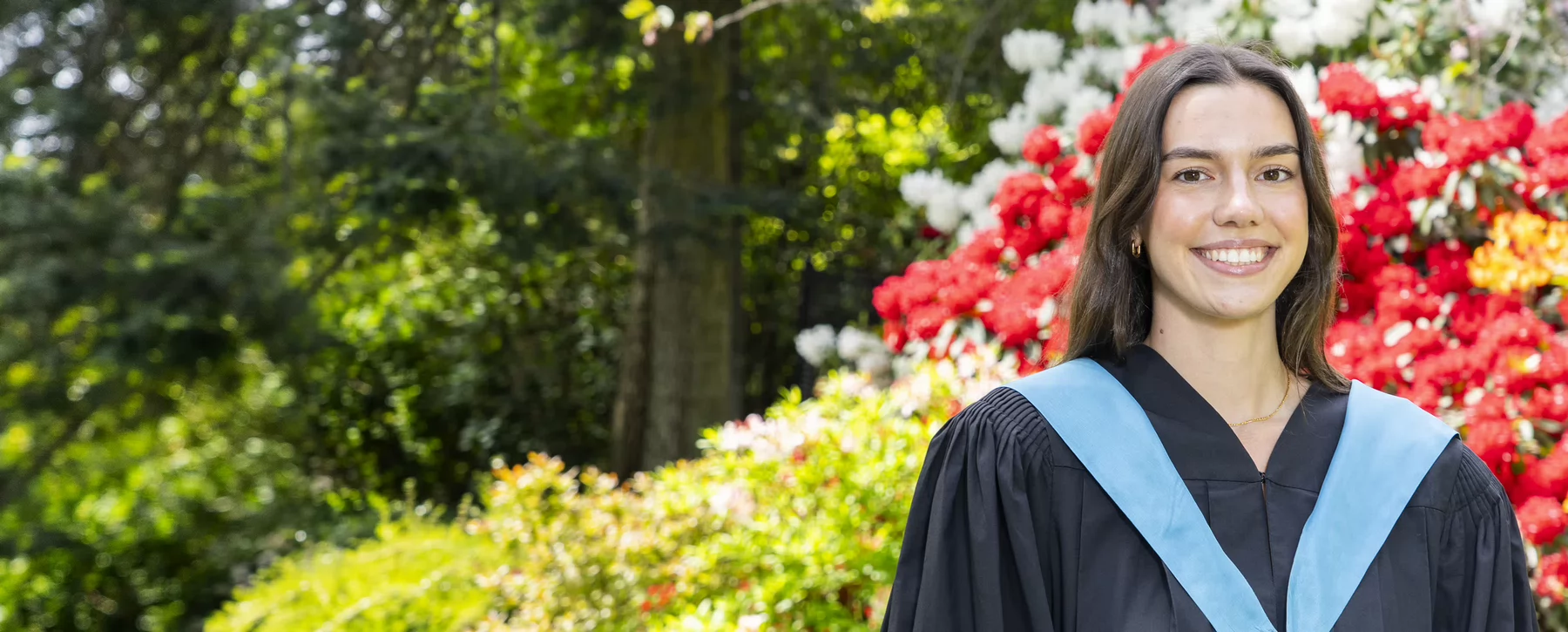 Graduating student and Vikes basketball athlete Tana Pankratz (Bachelor of Child and Youth Care) in Finnerty Gardens.nd a pink jacket