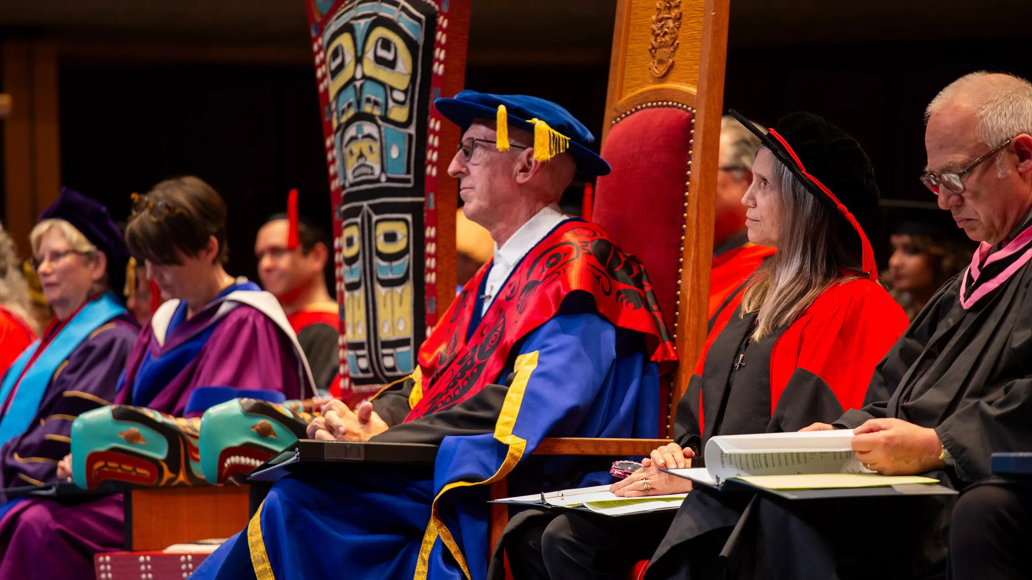 Dignitaries in full regalia on stage.