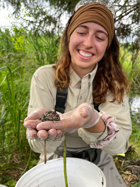student holding toad