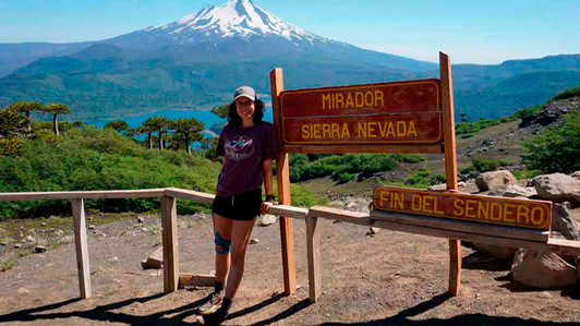 A student stands in front of a mountain in Nevada