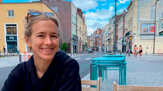 A student sits at a café in Europe.