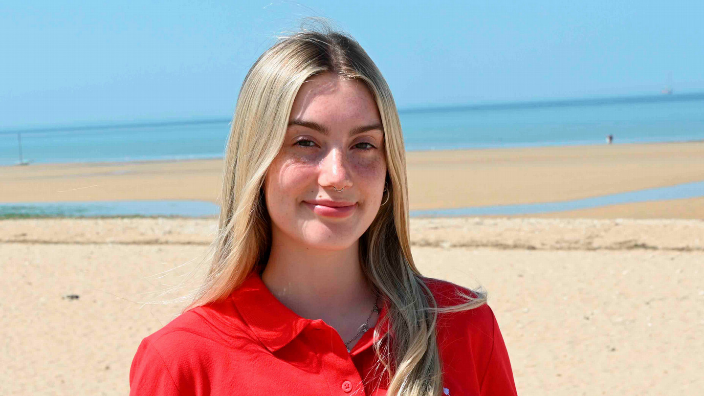 A student stands in front of Juno Beach in Normandy, France