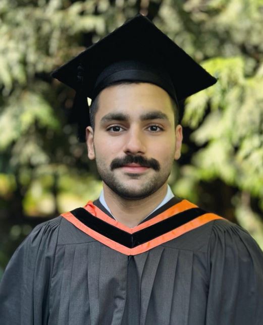 UVic Masters student, Ash Afshar in his cap and gown.