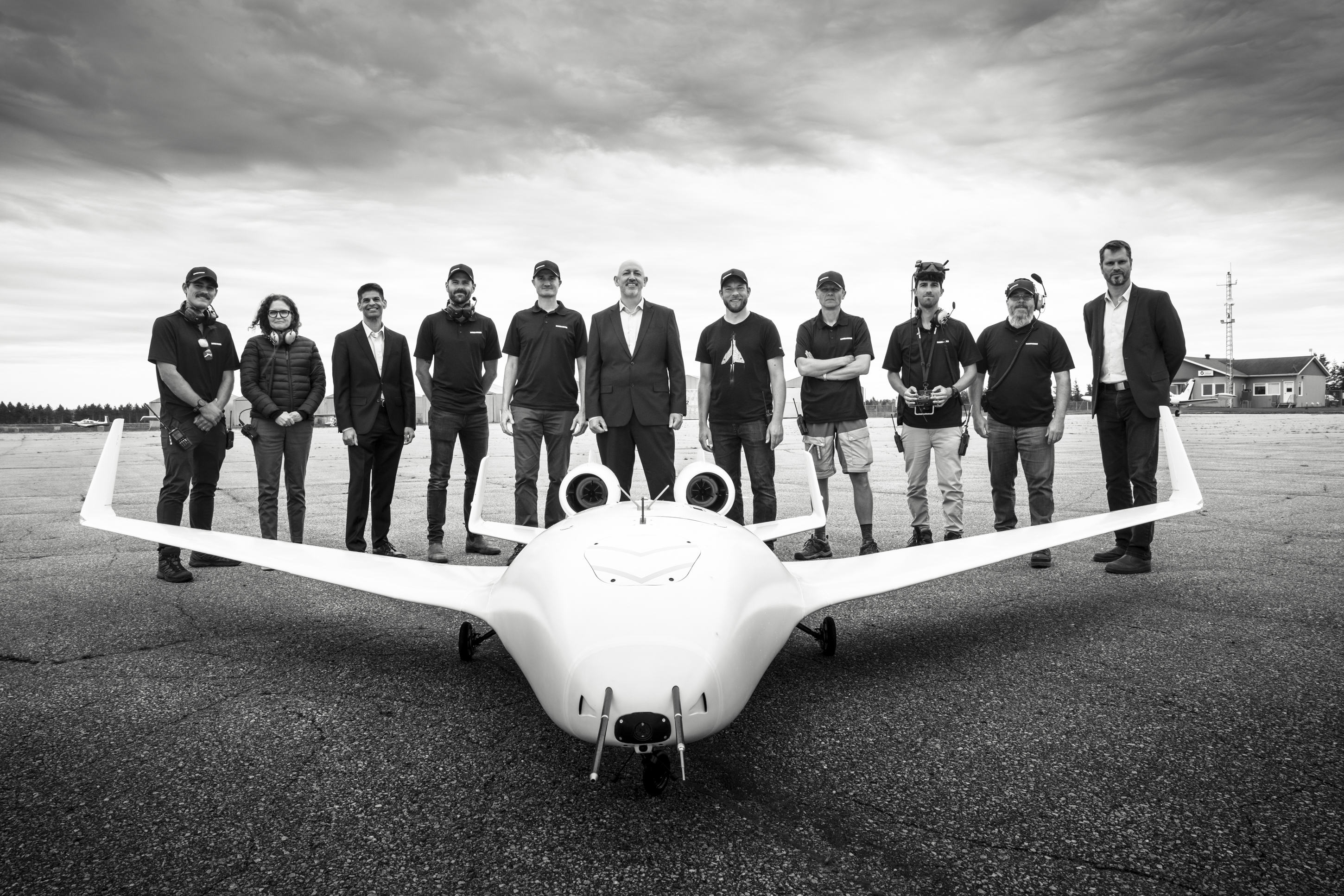 Members of CfAR and Bombardier standing in front of a small aircraft.