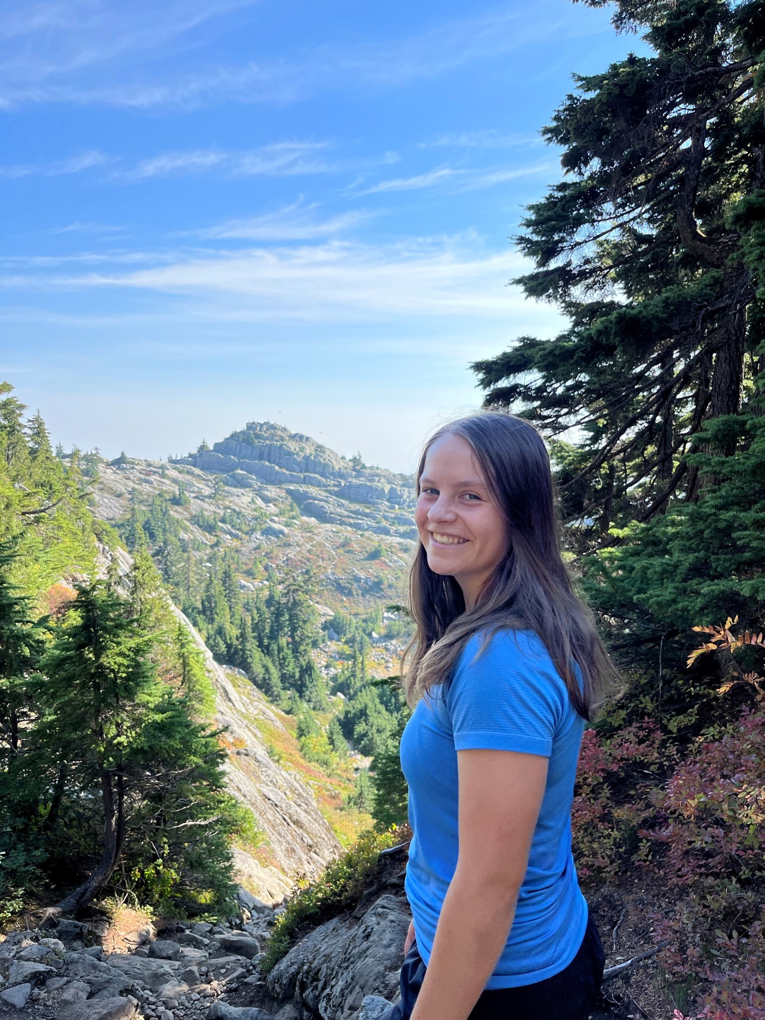 UVic student Emily Kay-Leighton standing in front of a mountain.