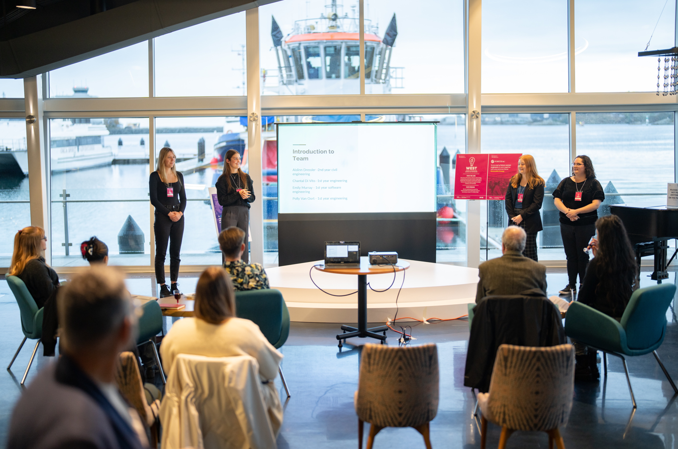 The Women in Engineering, Science and Technology members giving a presentation.